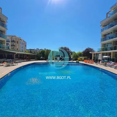 a large blue swimming pool in a resort at Sunny Holiday - Cacao Beach Apartments in Sunny Beach
