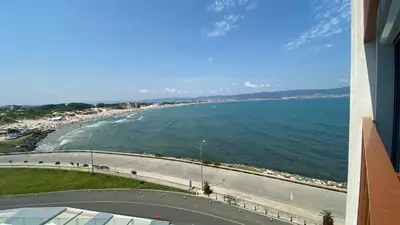 a view of a beach and the ocean from a building at PARADISO 'В' 201 One Bedroom Apartment in Nesebar