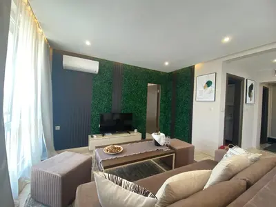 a living room with a couch and a tv at PARADISO 'В' 607 Large Luxury Apartment in Nesebar