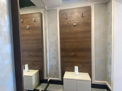 a bathroom with two toilets with wooden doors at PARADISO 'В' 607 Large Luxury Apartment in Nesebar