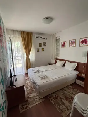 a bedroom with a large white bed and a window at Sunny apartment in Sunny Beach in Sunny Beach