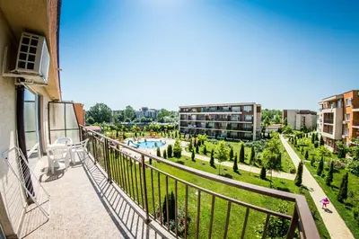 a balcony of a building with a view of a park at Waterpark Fort Apartments in Sunny Beach