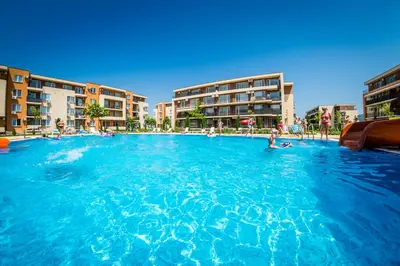 a large swimming pool with people in the water at Waterpark Fort Apartments in Sunny Beach