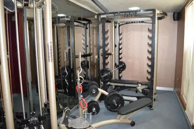a gym with several treadmills and weights at Harmony Palace in Sunny Beach
