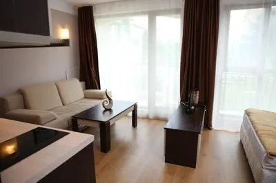 a living room with a couch and a table at Harmony Palace in Sunny Beach