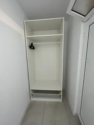 an empty white refrigerator in a white room at Aliara Dilara Beach Apartments in Pomorie
