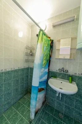 a bathroom with a shower curtain and a sink at Casa Del Mare in Chernomorets