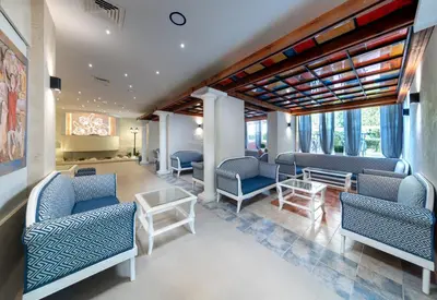 a waiting room with blue chairs and tables at Sentido Bellevue Beach- All Inclusive & Beach Access in Sunny Beach