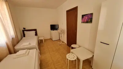 a small room with two beds and a table at S Apartment in Tsarevo