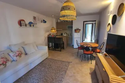 a living room with a white couch and a table at Oasis Resort Apartment, Луксозен Апартамент в комплекс ОАЗИС in Lozenets
