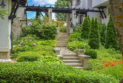a garden with stairs leading up to a house at Oasis Resort Apartment, Луксозен Апартамент в комплекс ОАЗИС in Lozenets