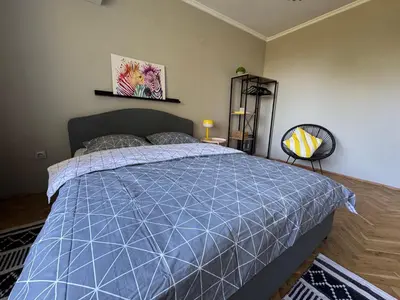 a bedroom with a bed with a blue comforter at LAZUR first line in Burgas City
