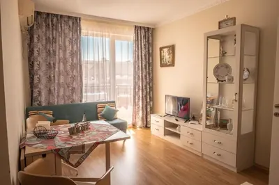 a living room with a couch and a table at Melia lux apartment in Ravda