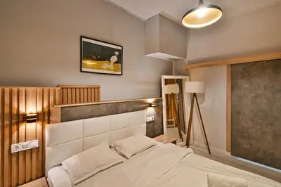 a bedroom with a bed and a picture on the wall at Central Flats with parking in Varna City