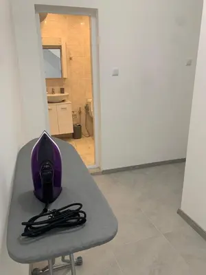 a purple bag sitting on a table in a room at Апартамент Енигма/Apart Enigma in Sveti Vlas