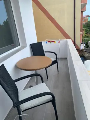 a small table and two chairs on a balcony at Апартамент Енигма/Apart Enigma in Sveti Vlas