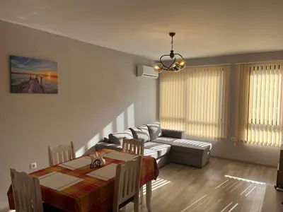 a living room with a table and a couch and a dining room at Apartment Mihaela - 2 in Burgas City