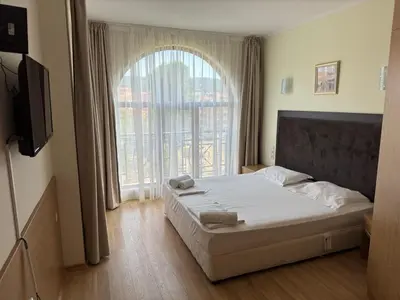 a bedroom with a bed and a large window at PACIFIC-3-A in Sunny Beach