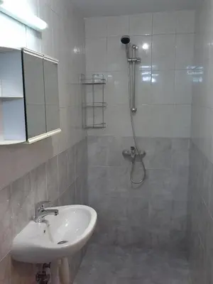 a bathroom with a shower and a sink at Morski Rai Apartments in Byala
