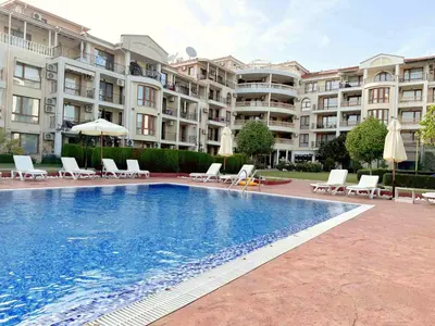 a swimming pool in front of a large apartment building at Apartment Royal Bay Sveti Vlas in Sveti Vlas