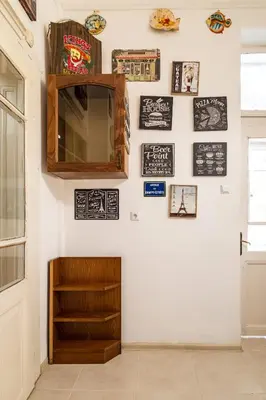 a room with a white wall with pictures and a mirror at Aristocratic 2bdrm Central Apartment in Varna City