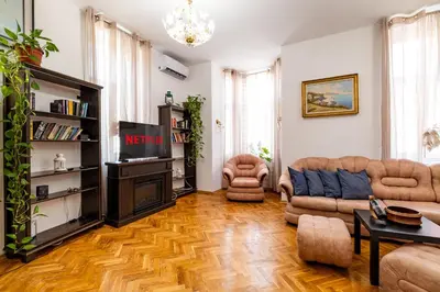 a living room with a couch and a tv at Aristocratic 2bdrm Central Apartment in Varna City