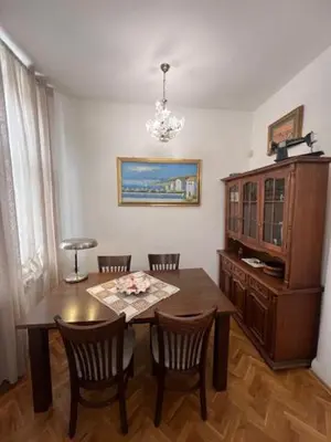 a dining room with a wooden table and chairs at Aristocratic 2bdrm Central Apartment in Varna City