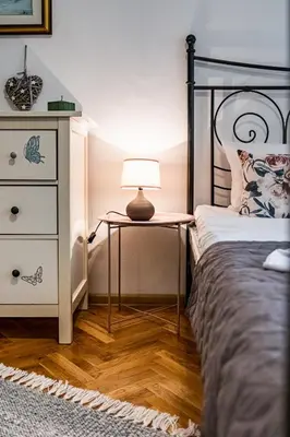 a bedroom with a bed and a table with a lamp at Aristocratic 2bdrm Central Apartment in Varna City