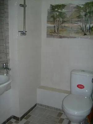 a bathroom with a toilet and a sink at Hotel Pasians in Pomorie