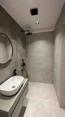 a bathroom with a white sink and a mirror at Amber Home - brand NEW luxury 1 bedroom apartment located in the very city center in Varna City