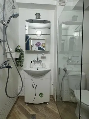 a bathroom with a shower and a sink and a toilet at The Master and Margarita Apartment, Майстора и Маргарита 2 in Burgas City