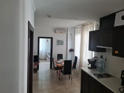 a kitchen and dining room with a table and chairs at Apartment Almi - The Cliff Obzor in Obzor
