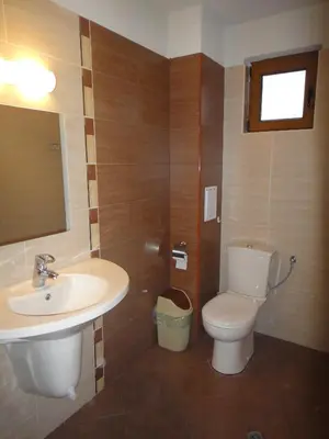 a bathroom with a toilet and a sink at Zenith Guest House in Sozopol