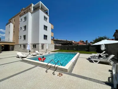a swimming pool in front of a building at Апартаменти Астрея Обзор - Apartments Astrea Obzor in Obzor
