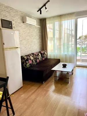 a living room with a couch and a refrigerator at Budget First Sea Line Apt. FLORA in Pomorie