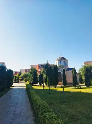a park with a building in the background and a walkway at Lovely bright studio on Sunny Beach in Sunny Beach