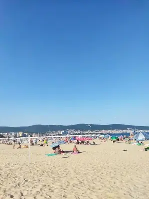 a group of people sitting on a beach at Lovely bright studio on Sunny Beach in Sunny Beach