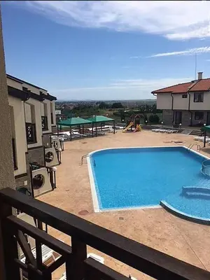a large swimming pool on a patio with a playground at Dream Villa in Imperial Heights Villas in Sunny Beach