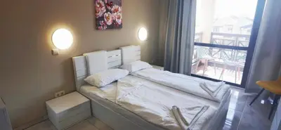 a small bedroom with a bed with a window at Dream Villa in Imperial Heights Villas in Sunny Beach