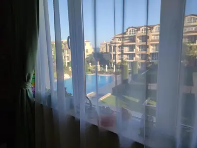 a view of a pool from a hotel room window at Apartments Atia Resort in Chernomorets