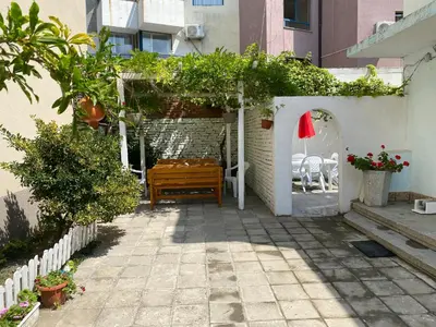 a patio with a wooden bench in a building at Romance in Pomorie