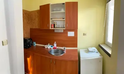 a small kitchen with a sink and a counter at Romance in Pomorie