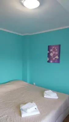 a blue room with a bed with towels on it at COCO Coworking & Coliving in Aheloy