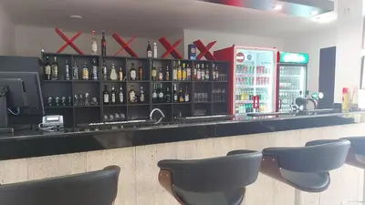 a bar with a lot of bottles of alcohol at COCO Coworking & Coliving in Aheloy