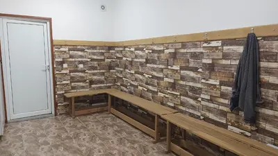 a brick wall with a bench in a room at COCO Coworking & Coliving in Aheloy