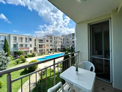 a balcony with a table and a view of a apartment at Апартамент Атлантик Бяла - Apartment Atlantic Byala in Byala