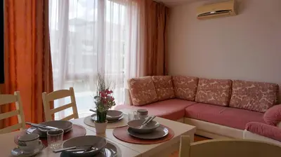a living room with a couch and a table at Апартамент Атлантик Бяла - Apartment Atlantic Byala in Byala