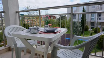 a white table and two chairs on a balcony at Апартамент Атлантик Бяла - Apartment Atlantic Byala in Byala