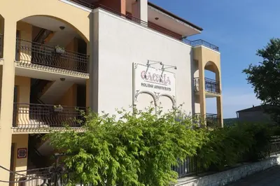 a building with a sign on the side of it at Galeria Holiday Apartments in Obzor