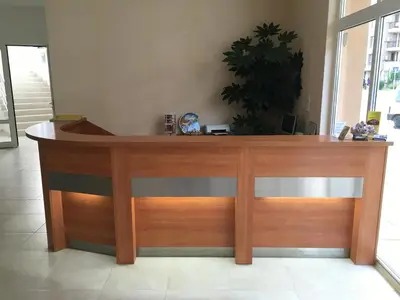 a wooden desk in a room with a clock on it at Beatris Family House in Sunny Beach